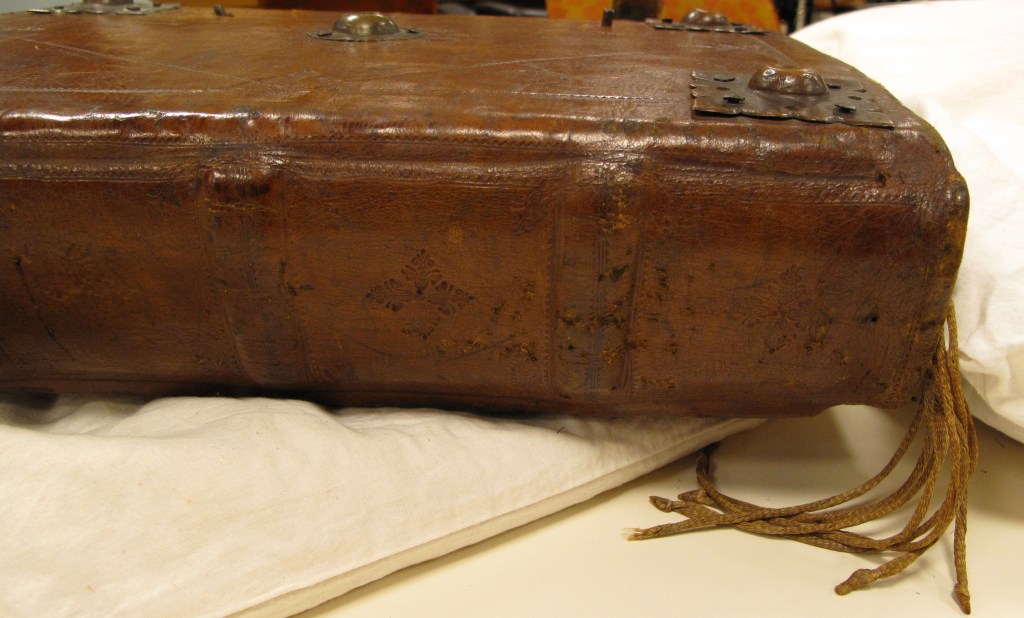 Auckland Libraries, Sir George Grey Special Collections, Med. MS S.1588 - spine of book showing ends of linen book markers and brass bosses